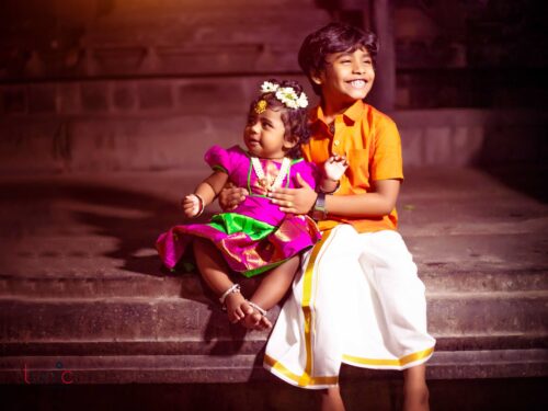 sweet siblings smile pose for traditional photography