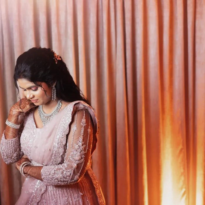 bridal photography poses 12 Candid bride portrait looking down shy pose in pink gown Erode Tamil Nadu