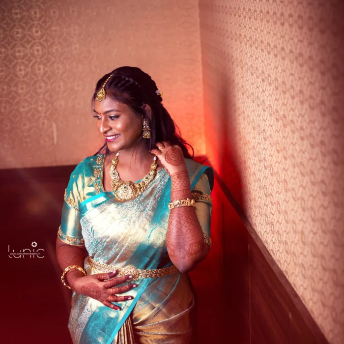 bridal photography poses 18 Cinematic bridal portrait in teal blue silk saree smiling pose with dramatic lighting Vellore Tamil Nadu